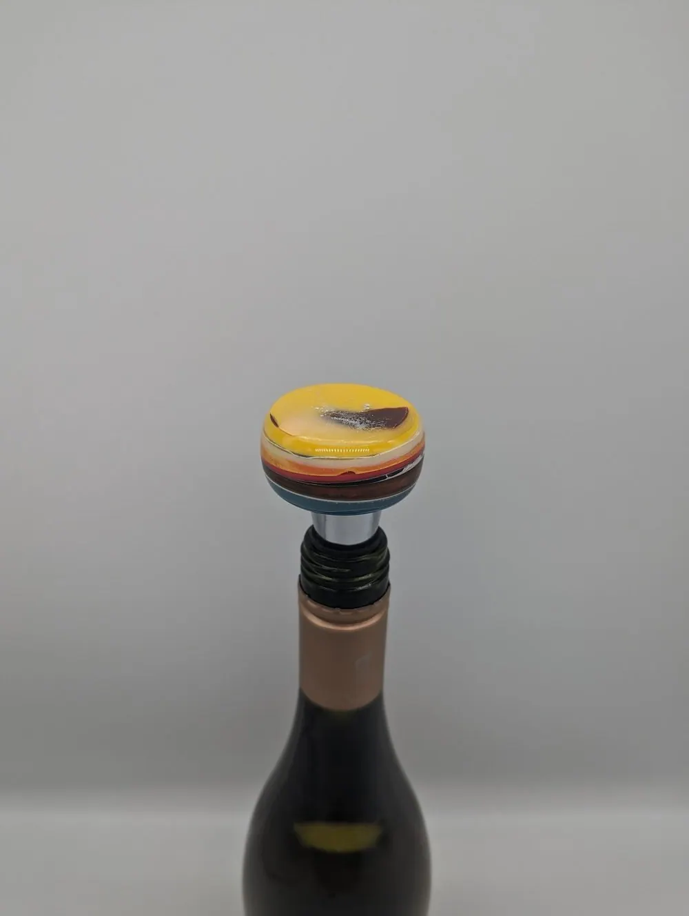 Wine bottle fitted with a colourful upcycled resin stopper.