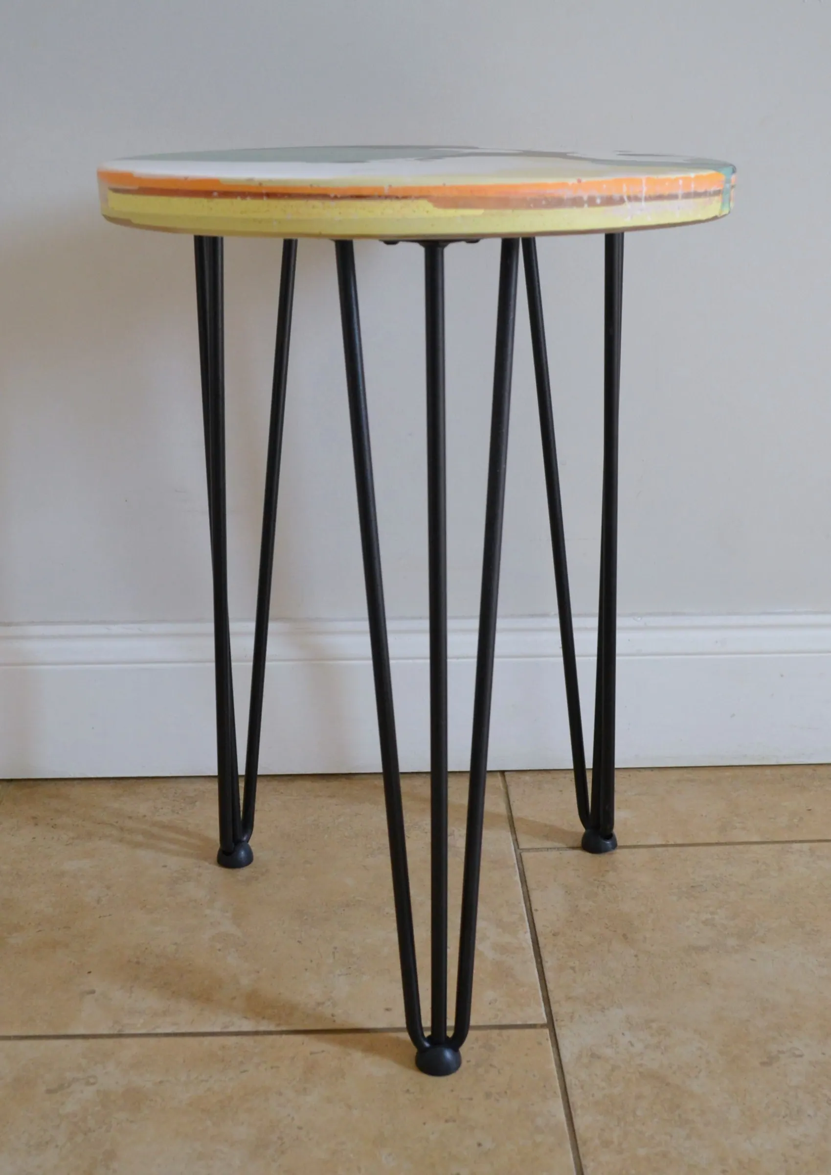 Green and black round side table made from workshop offcuts.