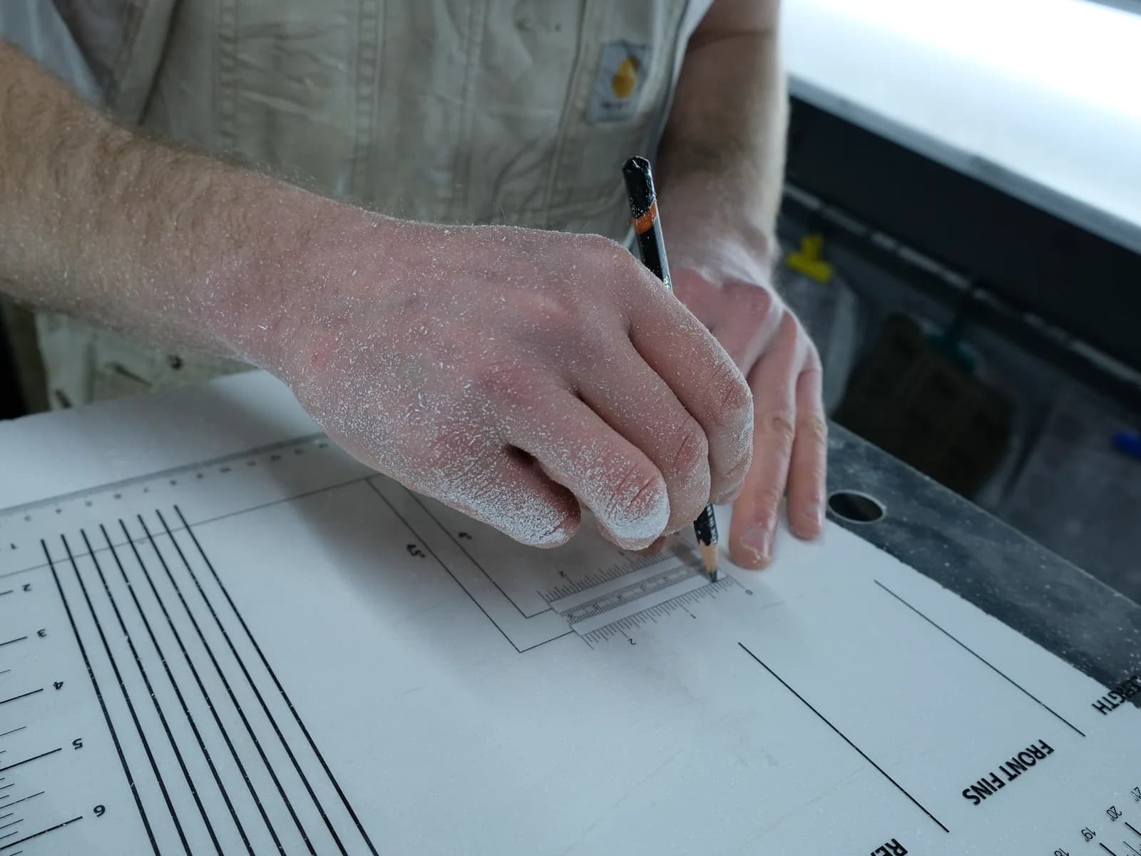 A sketched surfboard outline and workshop notes used to shape a custom board idea.