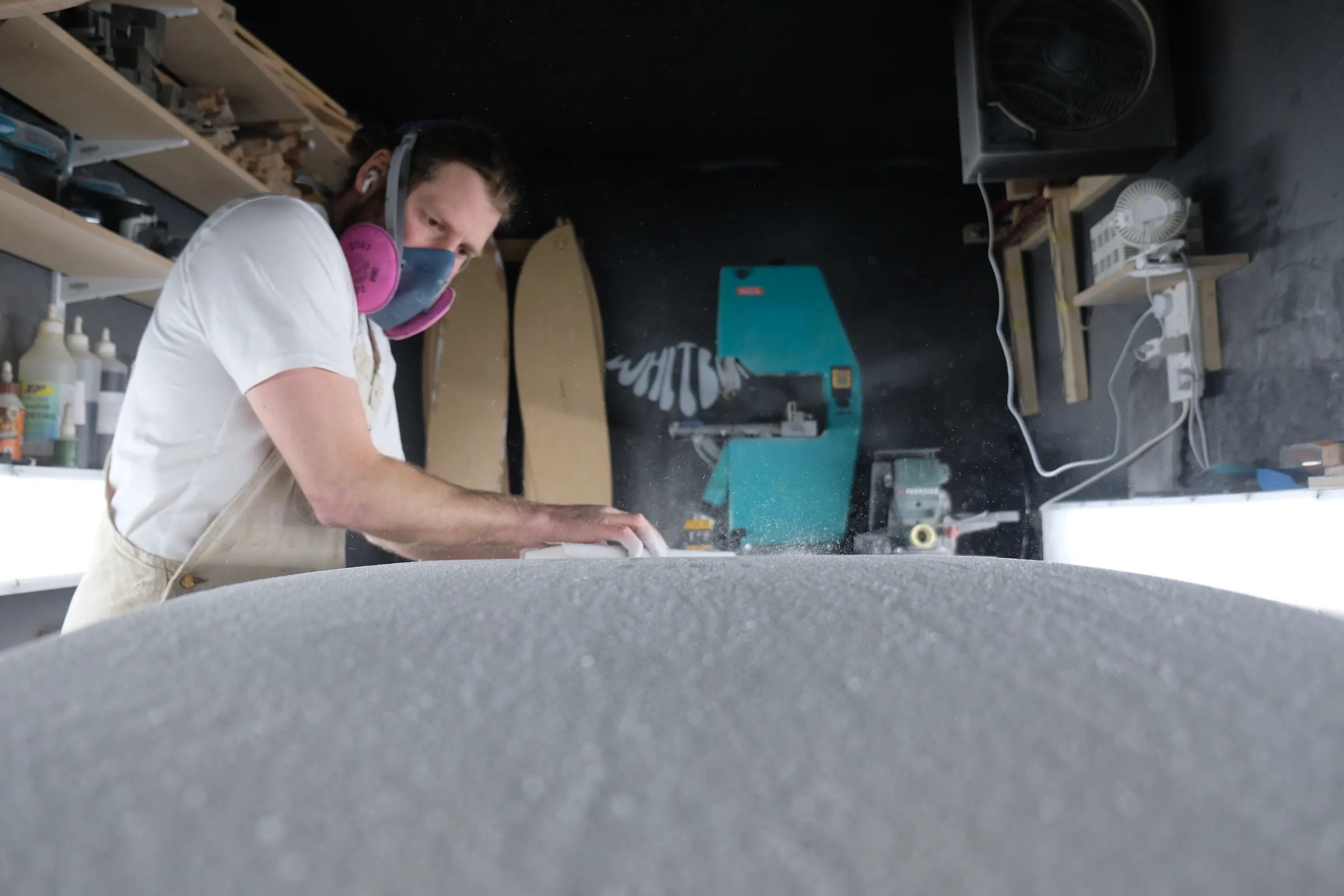 James shaping a surfboard blank in the Whitburn Studio shaping bay.